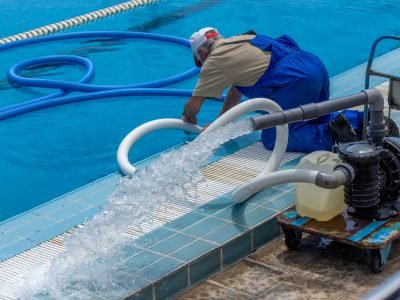 Cleaning the sports pool with a cleaning water pump. The water pump filters the water from the bottom of the pool, cleans from dirt and debris. The cleaning pump works with the pool.